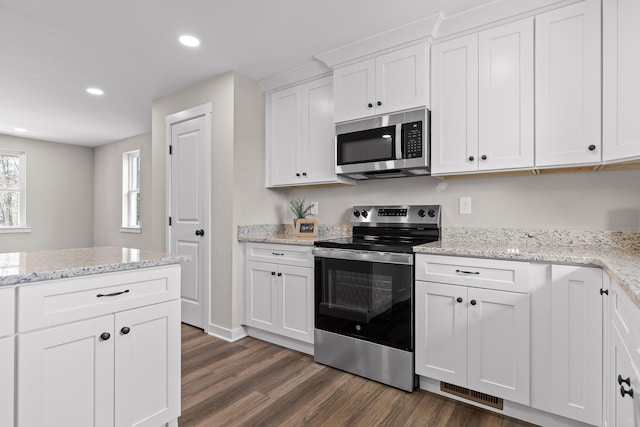 kitchen featuring recessed lighting, white cabinets, appliances with stainless steel finishes, and dark wood-style flooring