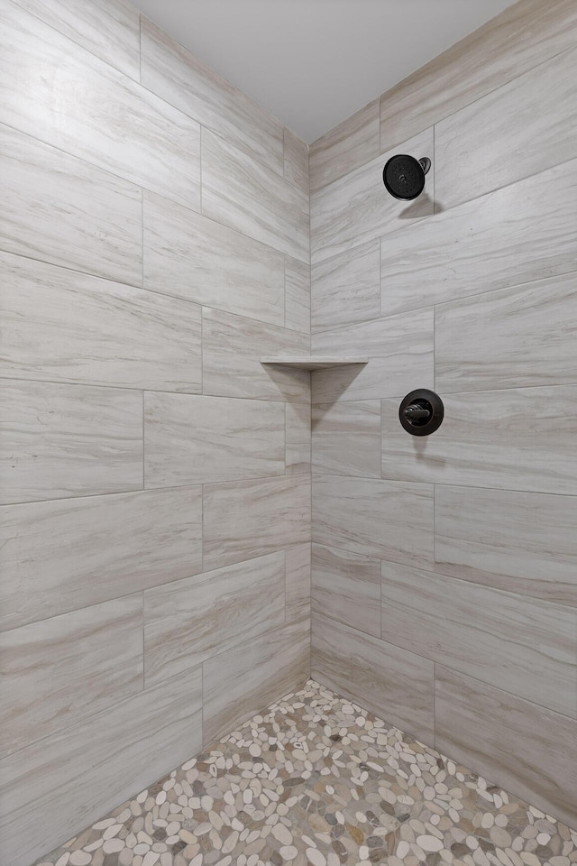 bathroom with tiled shower