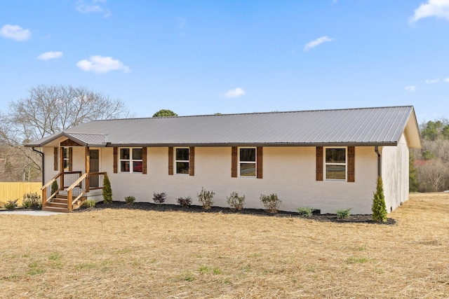 ranch-style house featuring metal roof