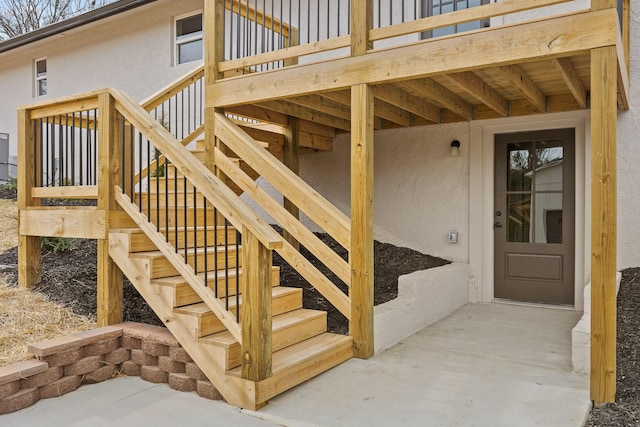 doorway to property featuring stucco siding