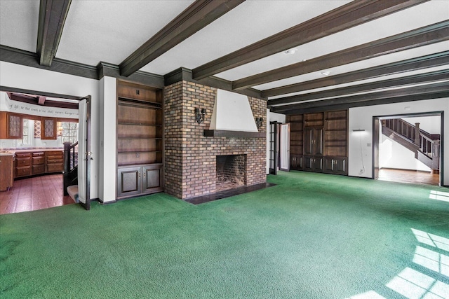 5803 Lake Resort Dr, Hixson, TN 37343 - unfurnished living room featuring beam ceiling, stairway, a fireplace, and carpet