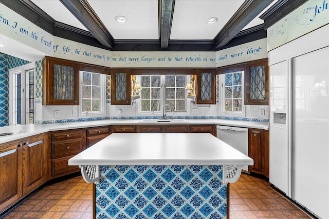 5803 Lake Resort Dr, Hixson, TN 37343 - kitchen featuring beamed ceiling, a sink, tasteful backsplash, white dishwasher, and light countertops