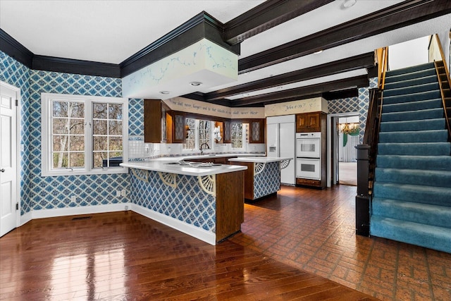5803 Lake Resort Dr, Hixson, TN 37343 - kitchen featuring wallpapered walls, light countertops, a peninsula, and baseboards