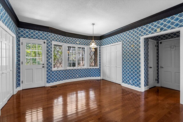 5803 Lake Resort Dr, Hixson, TN 37343 - unfurnished dining area featuring a textured ceiling, wallpapered walls, and baseboards