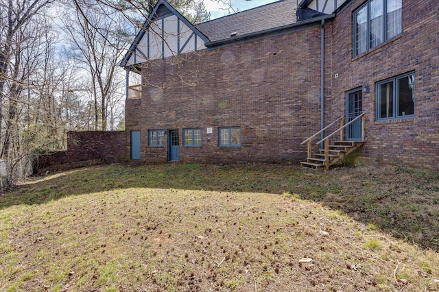 5803 Lake Resort Dr, Hixson, TN 37343 - back of house with entry steps, a lawn, brick siding, and roof with shingles