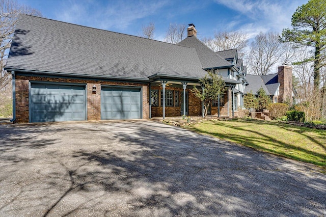 5803 Lake Resort Dr, Hixson, TN 37343 - view of front facade with a front yard, brick siding, driveway, and a chimney
