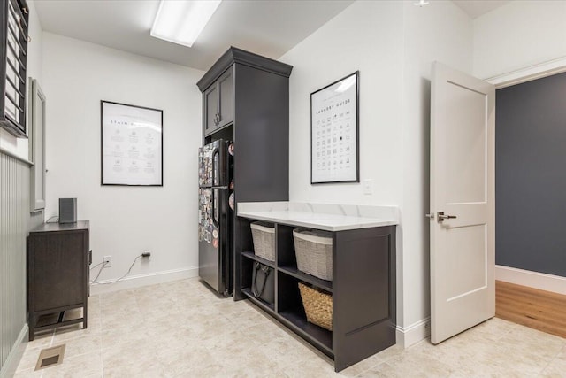 bathroom with tile patterned floors, visible vents, and baseboards