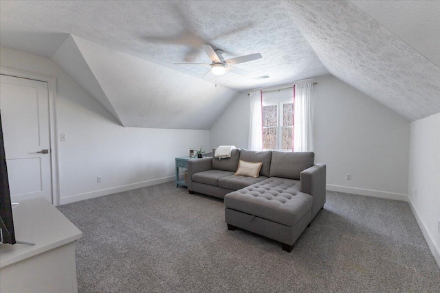 carpeted living area with ceiling fan, lofted ceiling, baseboards, and a textured ceiling