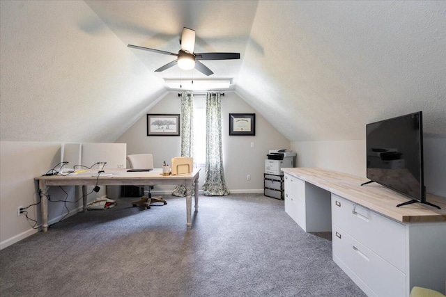 home office featuring a textured ceiling, a ceiling fan, baseboards, lofted ceiling, and light carpet