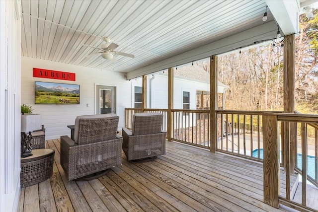 wooden deck featuring ceiling fan