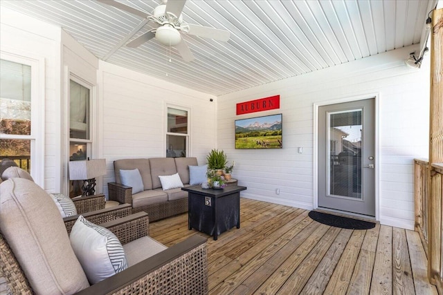 deck featuring an outdoor living space and ceiling fan