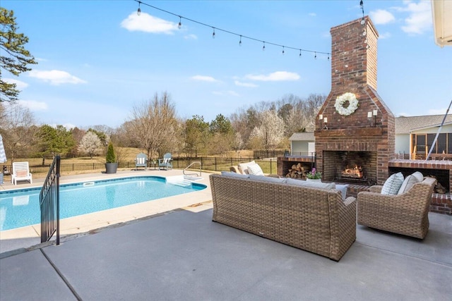 view of swimming pool with a patio, an outdoor living space with a fireplace, fence, and a fenced in pool