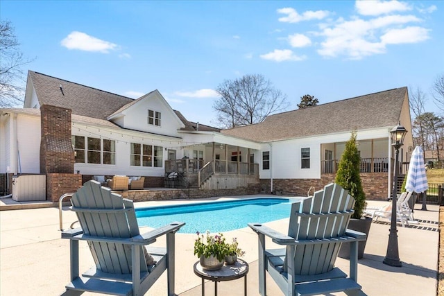 view of swimming pool with a fenced in pool and a patio