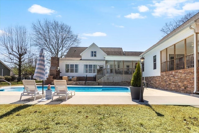 view of swimming pool featuring a fenced in pool, a patio, and a lawn