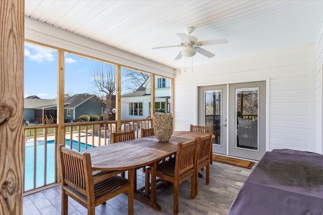 sunroom / solarium featuring a ceiling fan and french doors