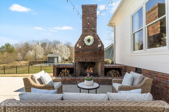 view of patio / terrace featuring an outdoor living space with a fireplace and fence