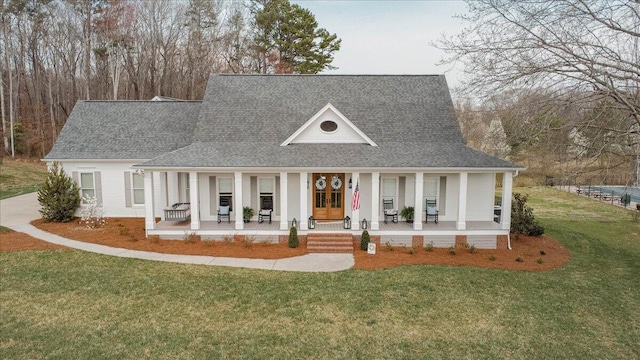 farmhouse with a porch, a front yard, and roof with shingles