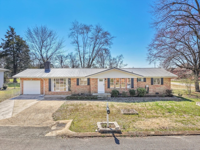 single story home featuring driveway, an attached garage, metal roof, brick siding, and a chimney