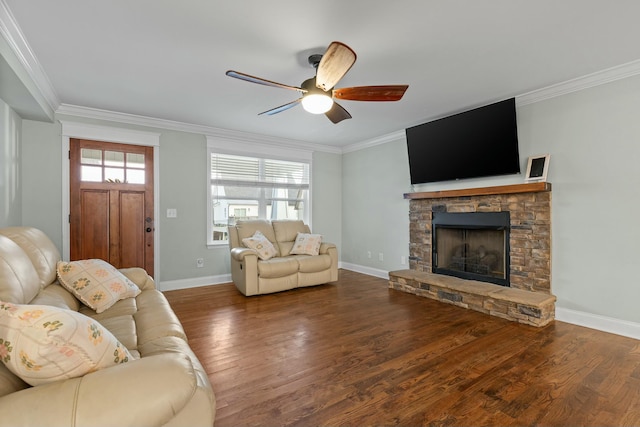 living room with wood finished floors, a fireplace, ceiling fan, and crown molding