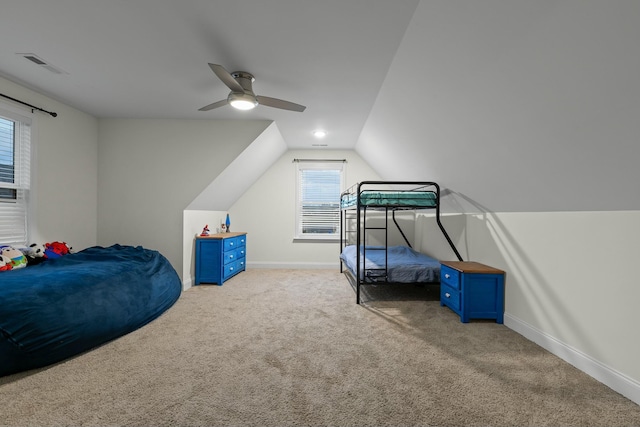 carpeted bedroom featuring visible vents, a ceiling fan, lofted ceiling, and baseboards