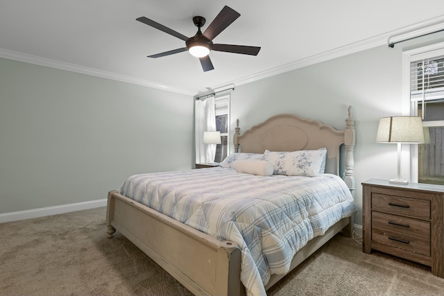 carpeted bedroom with baseboards, ceiling fan, and crown molding