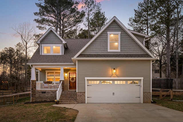 craftsman-style house featuring a porch, fence, a garage, and driveway