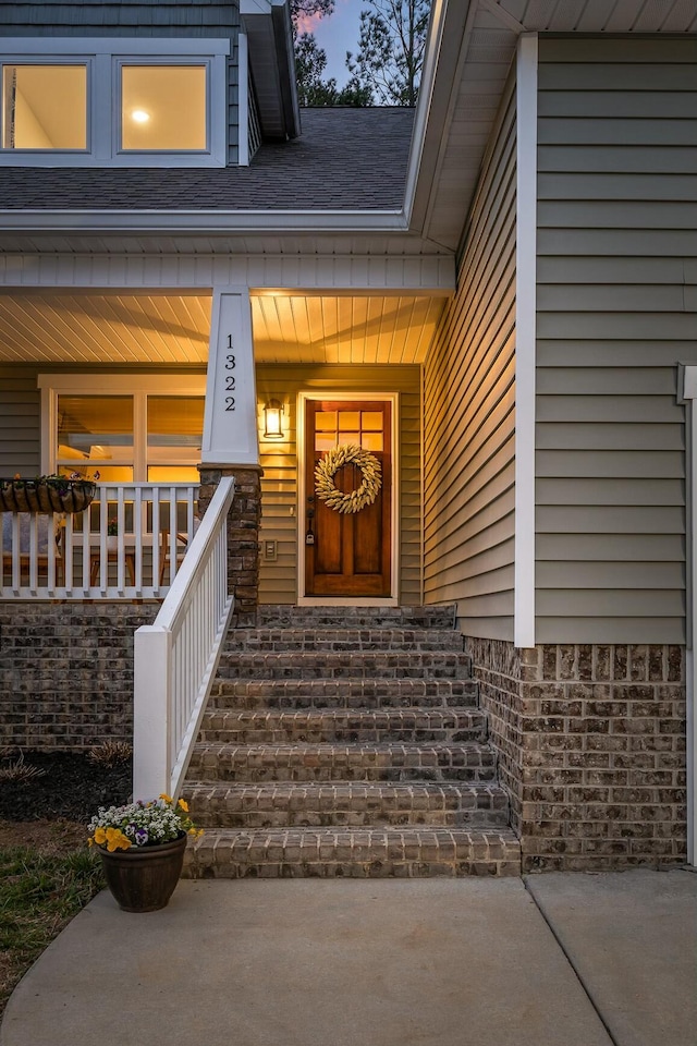 doorway to property featuring a porch