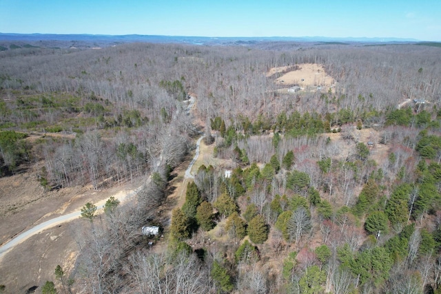 birds eye view of property with a view of trees