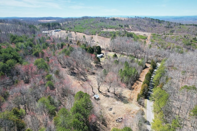 drone / aerial view with a wooded view