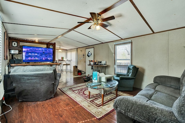 living room with vaulted ceiling, a ceiling fan, and wood finished floors