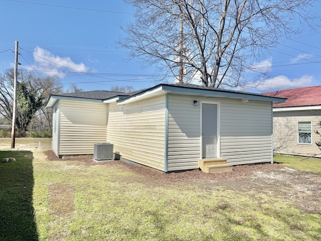 view of outbuilding featuring entry steps and cooling unit