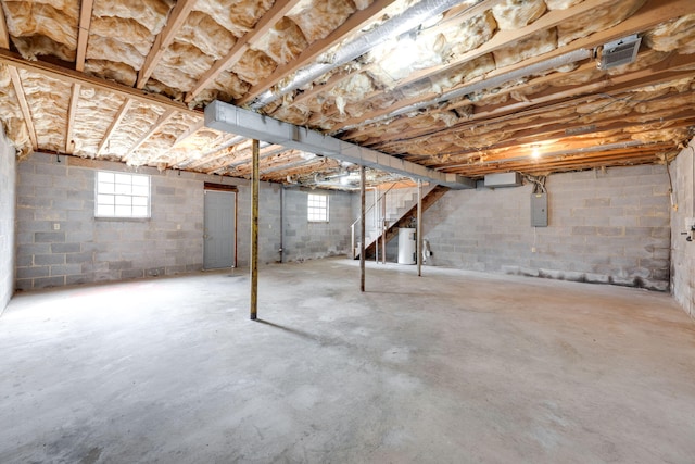 basement featuring electric panel and stairs