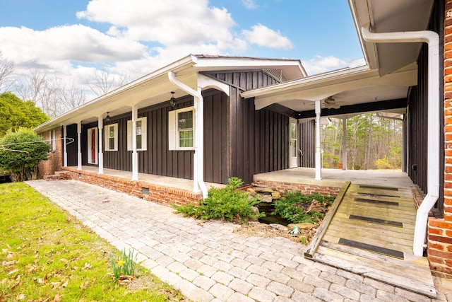 view of side of home featuring a porch and board and batten siding