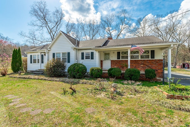 single story home featuring a front lawn and brick siding