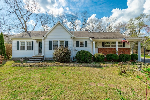 single story home with a chimney, a carport, and a front lawn