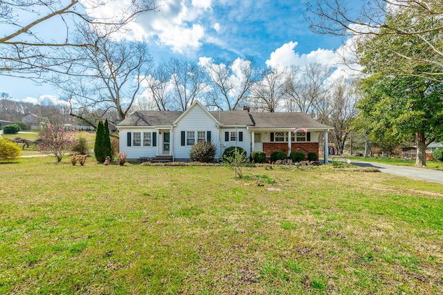 single story home with brick siding and a front lawn