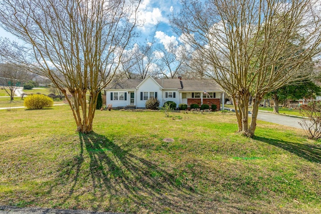 ranch-style house with brick siding and a front lawn