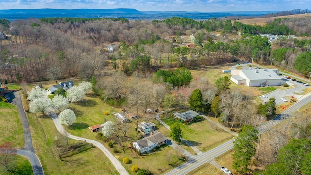 birds eye view of property with a wooded view