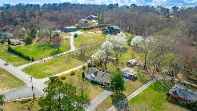 drone / aerial view with a wooded view