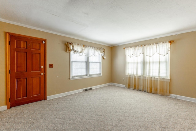 empty room with baseboards, visible vents, and carpet