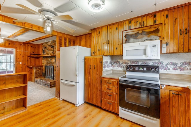kitchen with light wood finished floors, white appliances, light countertops, and ceiling fan