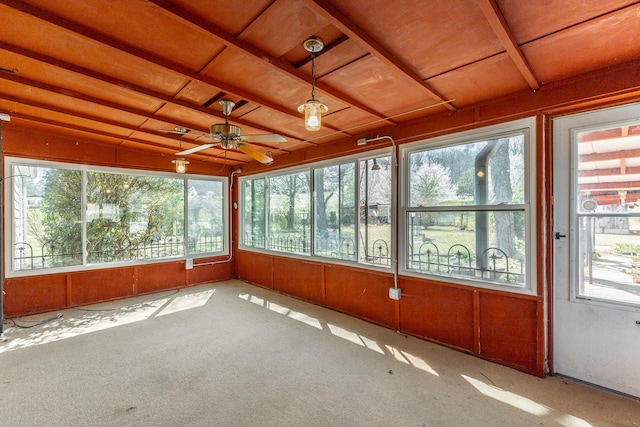 unfurnished sunroom featuring plenty of natural light and a ceiling fan