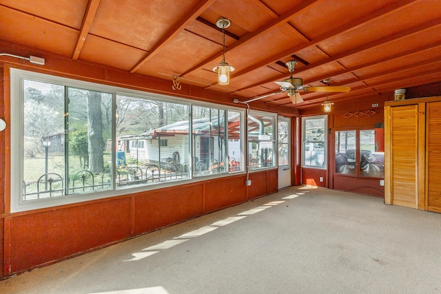 unfurnished sunroom with ceiling fan