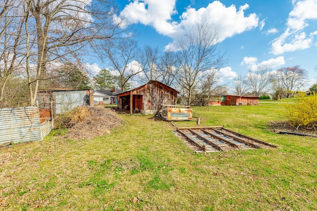 view of yard featuring fence and an outdoor structure