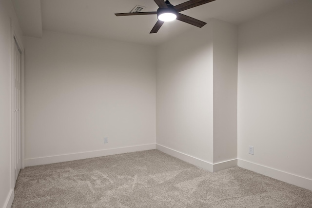 unfurnished room with visible vents, baseboards, a ceiling fan, and carpet floors