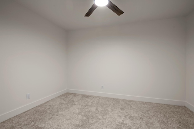 unfurnished room with ceiling fan, baseboards, and light carpet