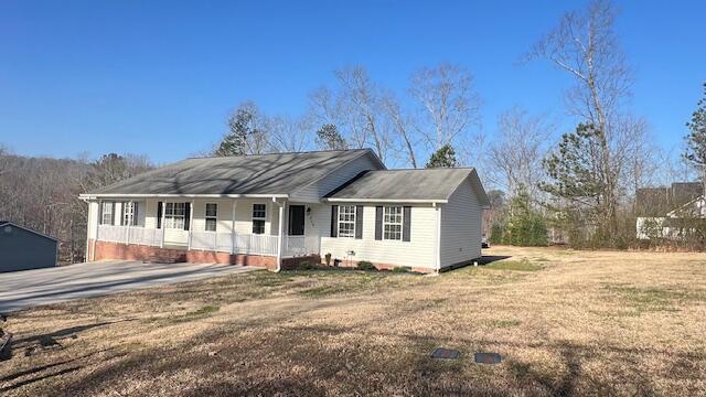 single story home featuring a front lawn and covered porch