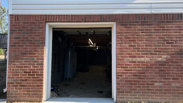 view of exterior entry with brick siding