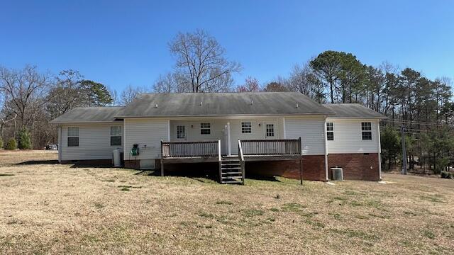 back of property featuring a yard, central AC unit, and a deck