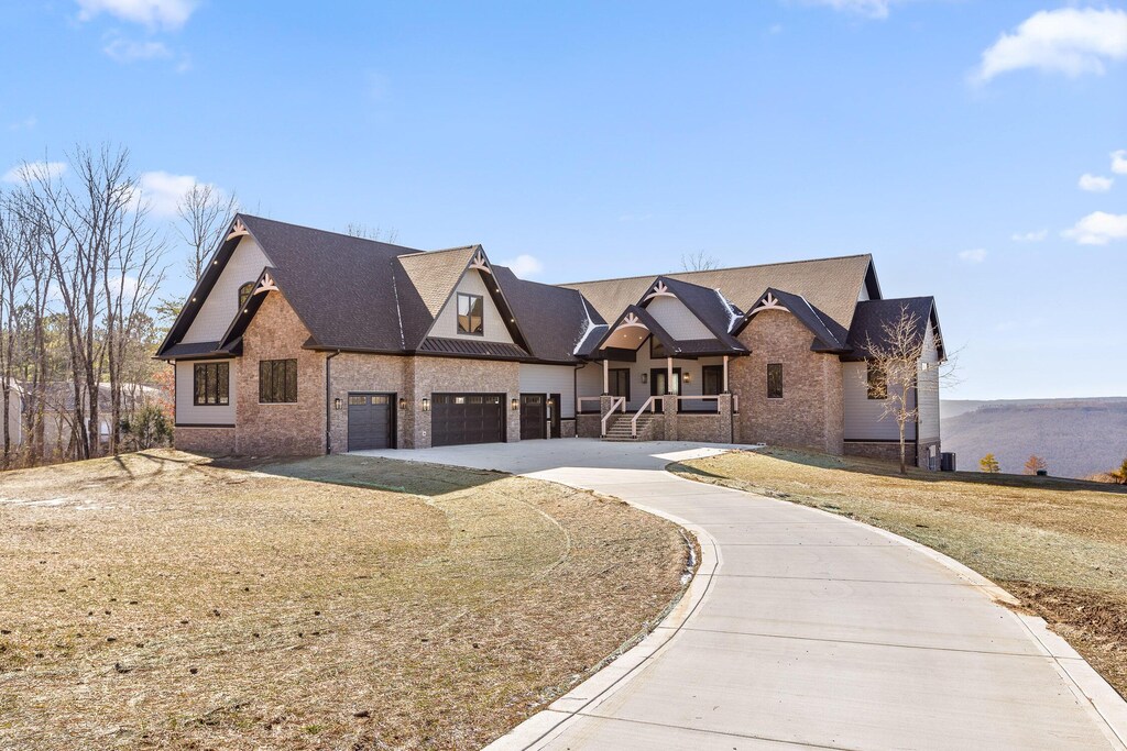 490 Pappy Rd, Jasper, TN 37347 - view of front facade with driveway, brick siding, and an attached garage